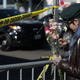 A woman places flowers on a post outside a police line following an overnight fire that claimed the lives of at least 24 people at a warehouse in the Fruitvale neighborhood on Dec. 3, 2016, in Oakland, Calif. The warehouse was hosting an electronic music party.
Elijah Nouvelage/Getty Images